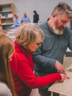 Archivist and researchers looking at a township map at the Provincial Archives of Alberta